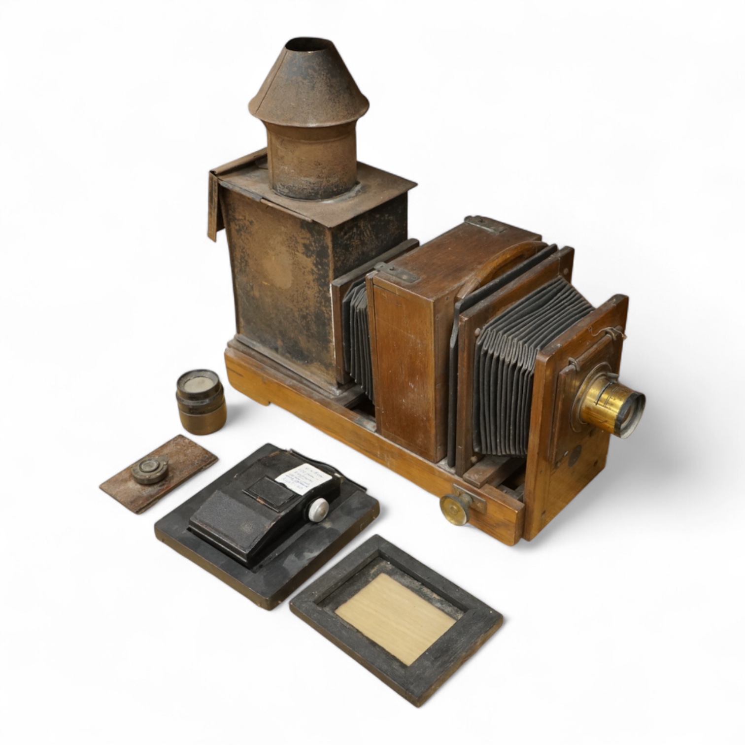 A late 19th century mahogany and tinplate magic lantern style horizontal photograph enlarger, together with some related items.